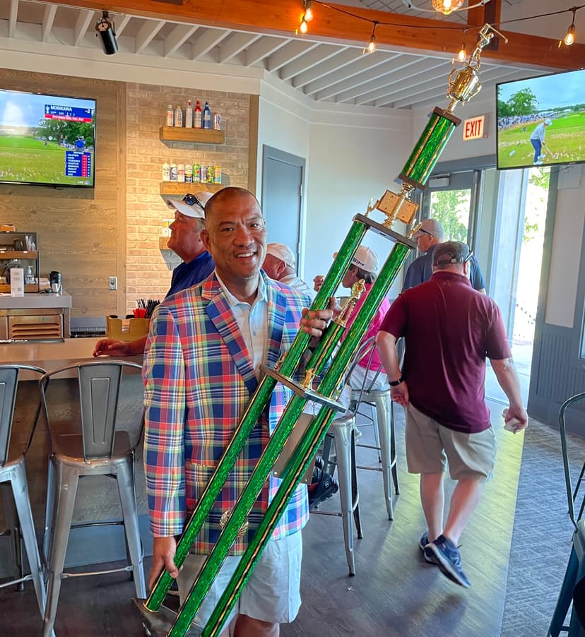 Pat Tallungan celebrating with golf trophy